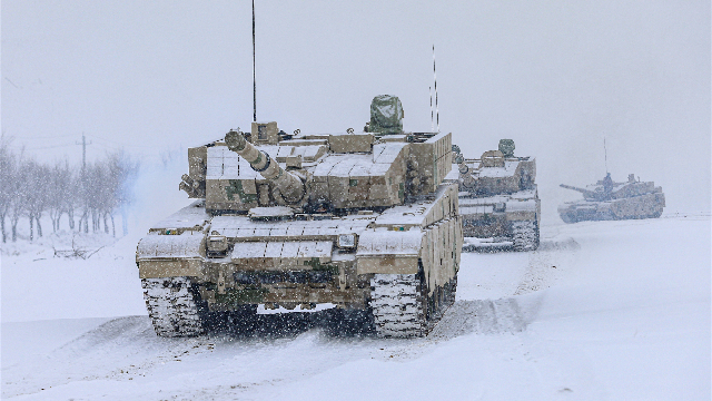 Main battle tanks rumble in snow-covered area